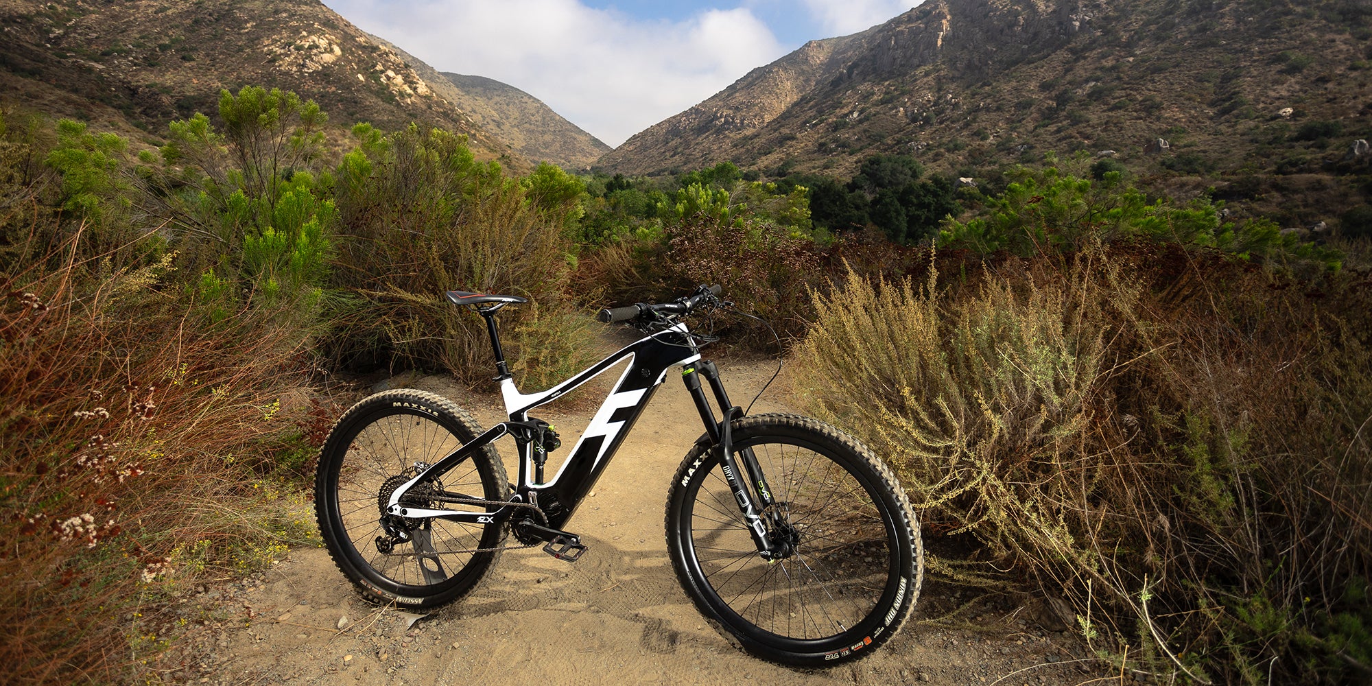 Electric Mountainbike on trail with mountains in the background 