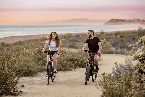 man and woman riding step-through bikes in san diego