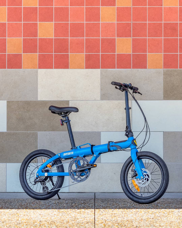 Shapeshifter electric bike by Superhuman with Brick wall in the background.