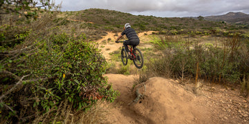 Man jumping with an electric Mountainbike on a trail